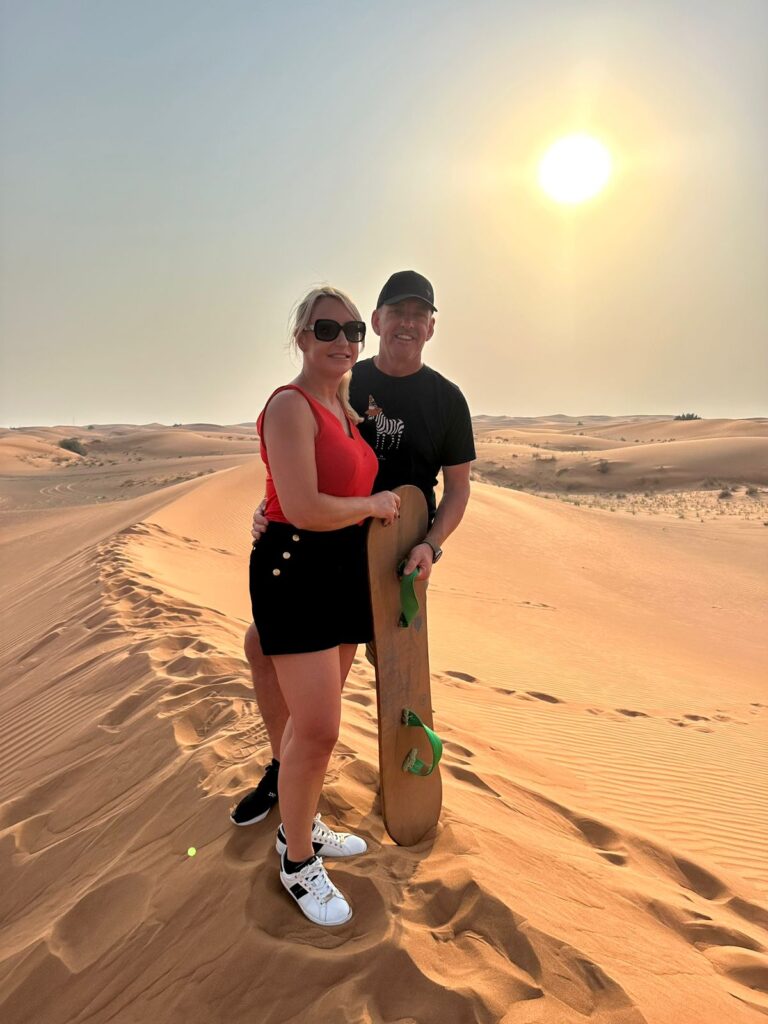 Sandboarding and taking desert pictures on the Dubai Desert Safari Experience