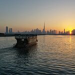 Dubai Creek sunset with dhow and Burj Khalifa