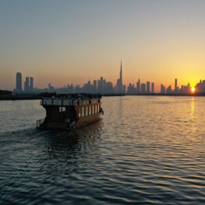 Dubai Creek sunset with dhow and Burj Khalifa